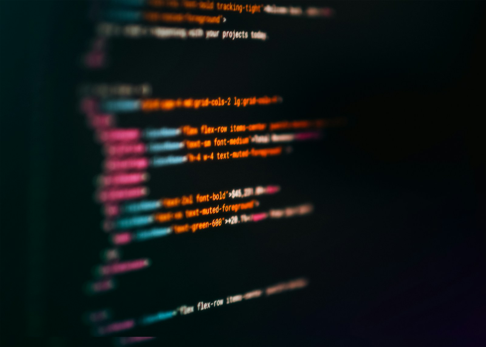 Blurred lines of HTML markup with pink tags and orange class names on a black code editor screen