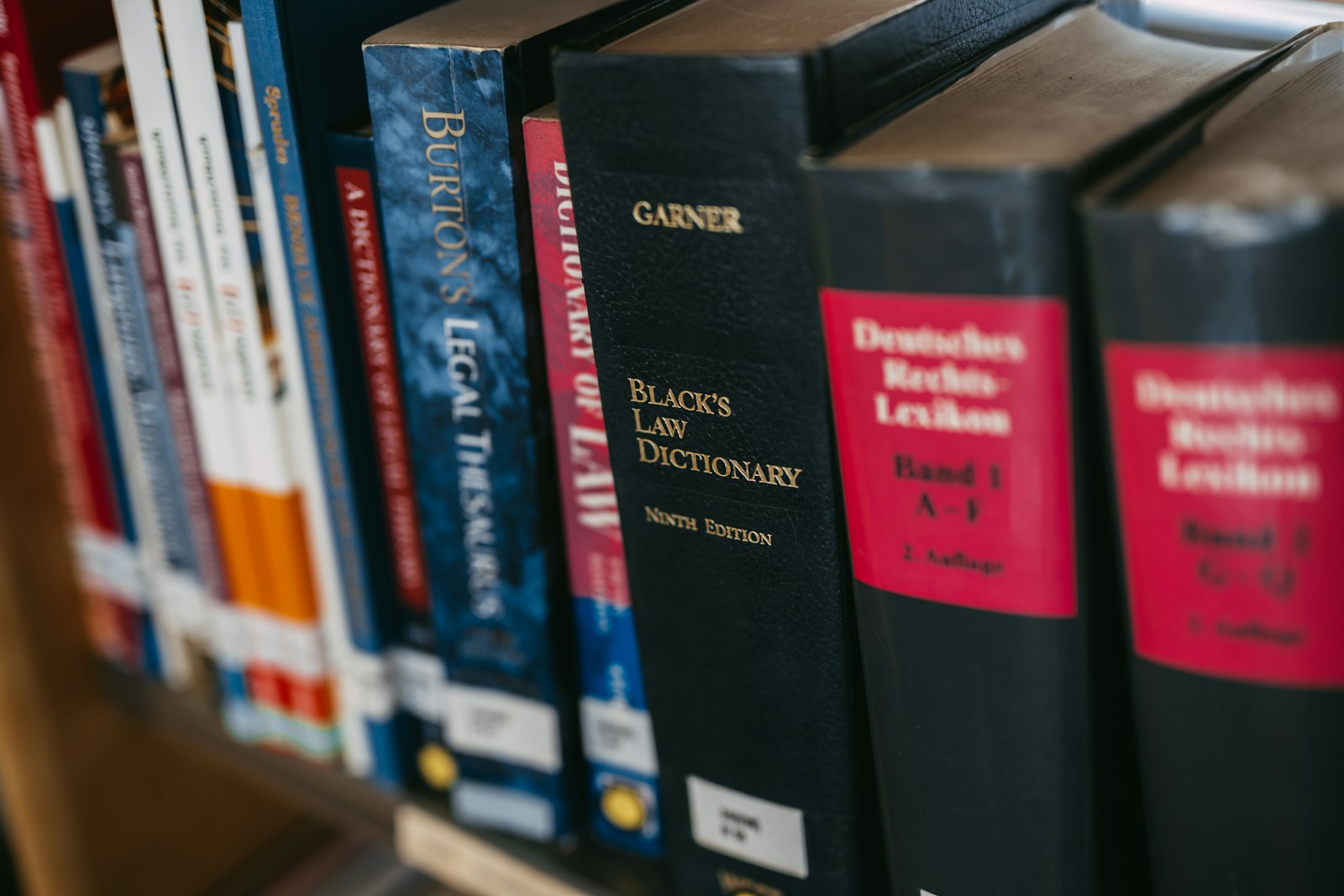 Spines of law books on a shelf, including Black's Law Dictionary ninth edition and a German legal encyclopedia