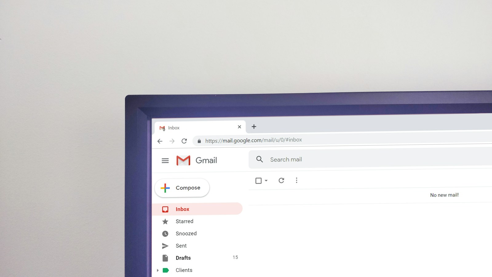 The corner of a computer monitor showing an email inbox with the message no new mail and 15 drafts