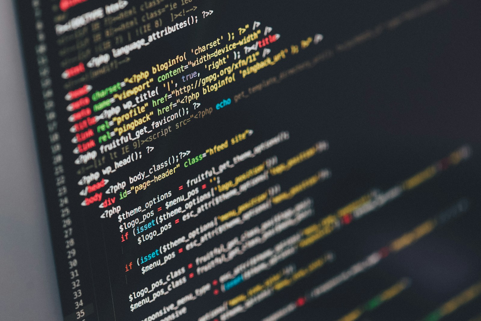 Close-up of a dark code editor showing a website theme's HTML head and body tags with PHP template code